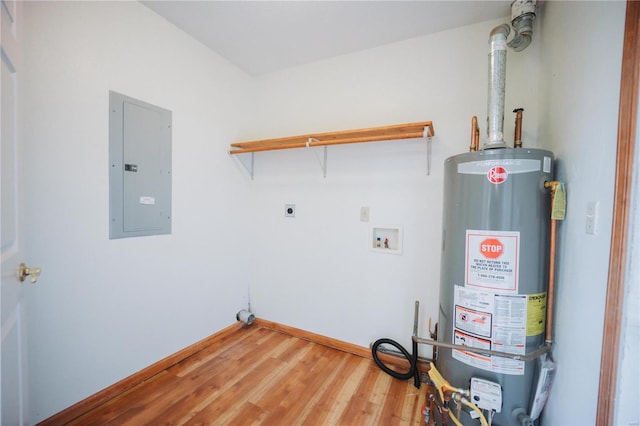 washroom with water heater, hardwood / wood-style flooring, hookup for an electric dryer, electric panel, and washer hookup