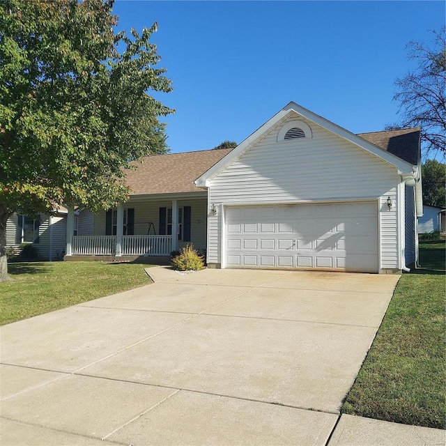 single story home with covered porch, a garage, and a front yard