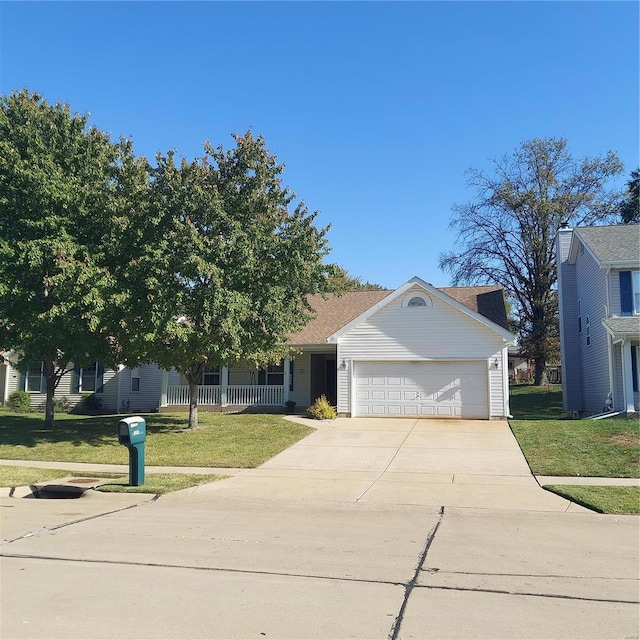 view of front of house with a front yard and a garage