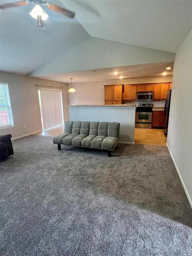 living room featuring ceiling fan, vaulted ceiling, and light colored carpet