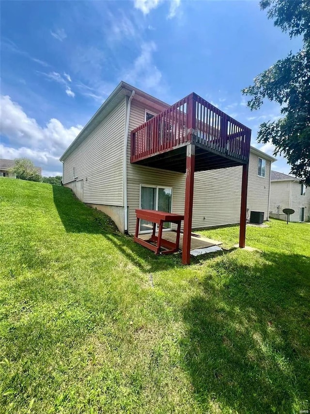 rear view of house featuring a yard, a deck, and central AC