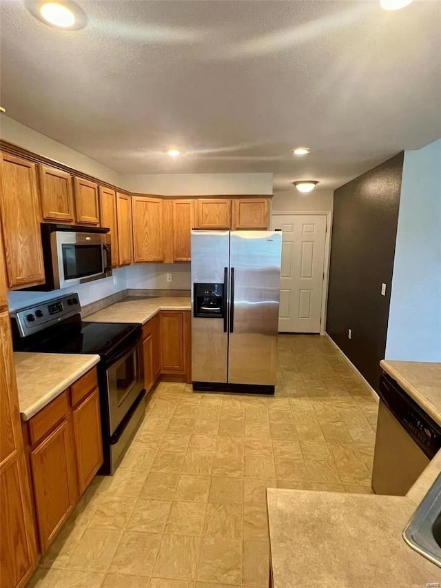 kitchen featuring appliances with stainless steel finishes and a textured ceiling