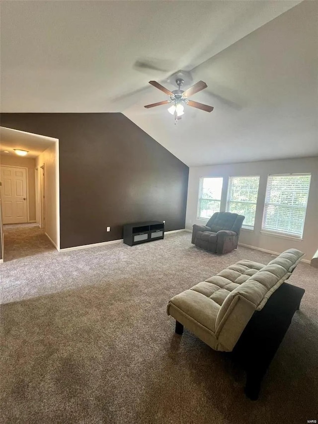 interior space with lofted ceiling, carpet flooring, and ceiling fan