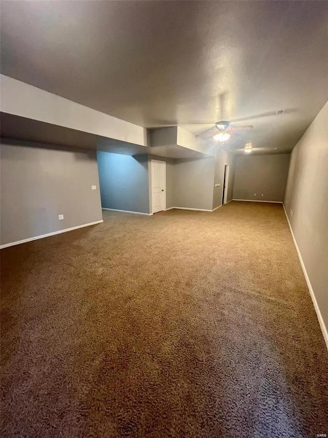 basement with carpet flooring and ceiling fan