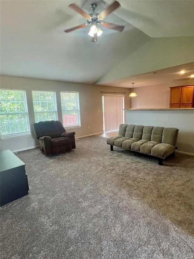 carpeted living room featuring ceiling fan and vaulted ceiling