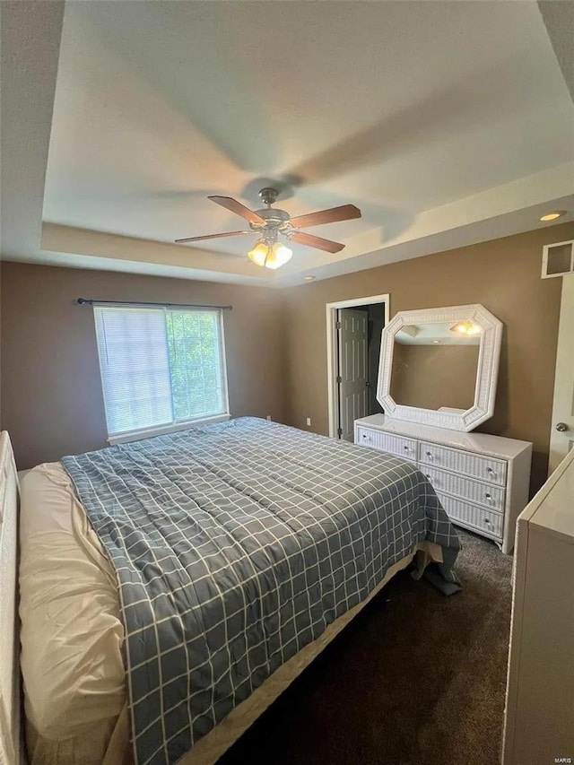 bedroom with dark carpet and ceiling fan