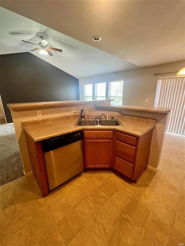 kitchen with sink, light carpet, ceiling fan, vaulted ceiling, and stainless steel dishwasher