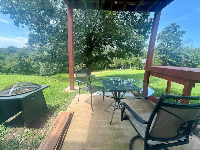 view of patio / terrace with central AC and a fire pit