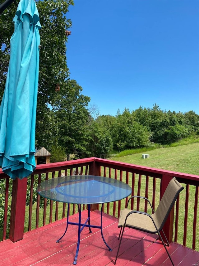 wooden deck with a lawn