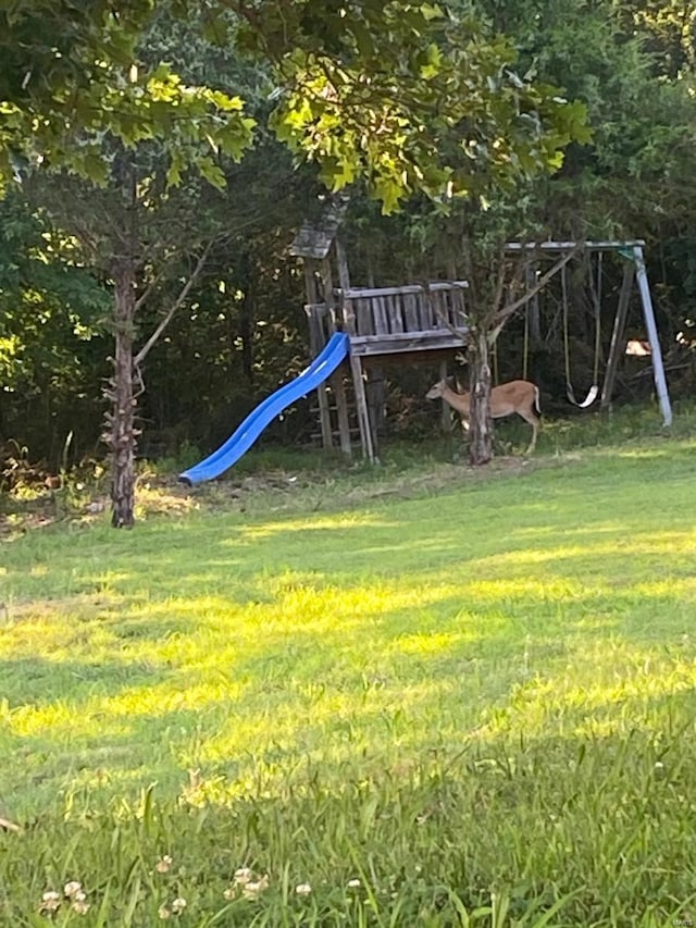 view of playground with a lawn