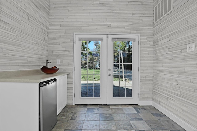 doorway featuring french doors and wood walls