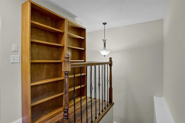 stairway with a textured ceiling