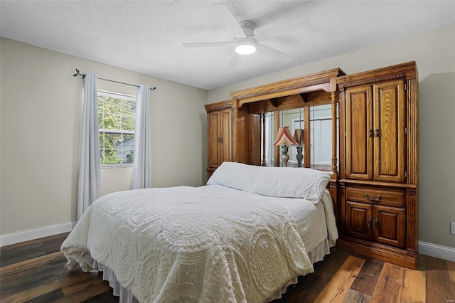 bedroom featuring ceiling fan, a textured ceiling, and dark hardwood / wood-style floors