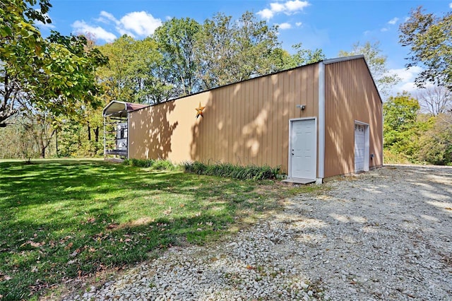 view of outdoor structure featuring a garage and a lawn