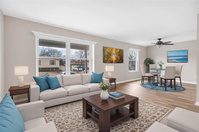 living room with hardwood / wood-style floors and ceiling fan