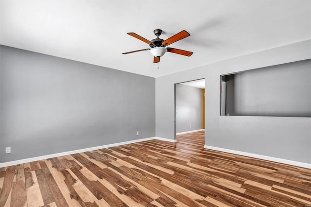 spare room with ceiling fan and hardwood / wood-style flooring