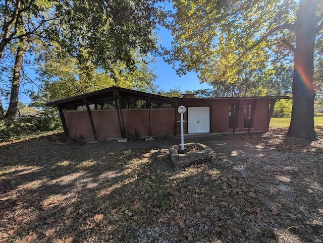 view of outbuilding featuring an outdoor fire pit