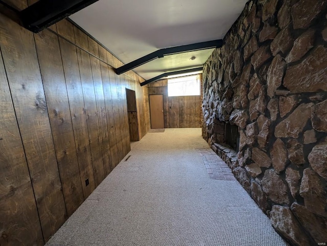 bonus room with light colored carpet, wooden walls, and lofted ceiling with beams