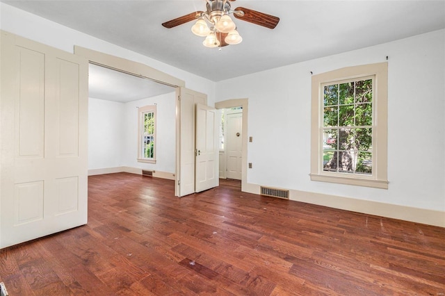 unfurnished room with ceiling fan and dark hardwood / wood-style flooring