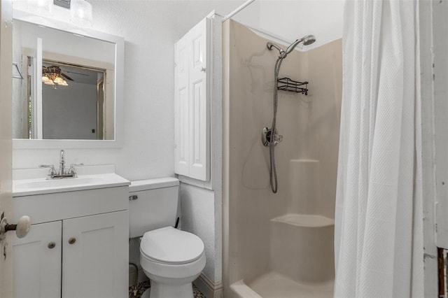 bathroom featuring vanity, toilet, a shower with curtain, and ceiling fan