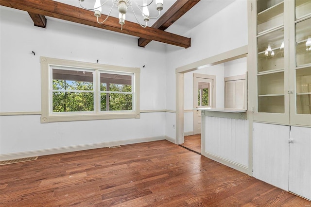 interior space with beam ceiling, a notable chandelier, and hardwood / wood-style floors