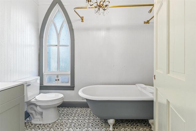 bathroom featuring a washtub, toilet, vanity, a notable chandelier, and tile patterned flooring