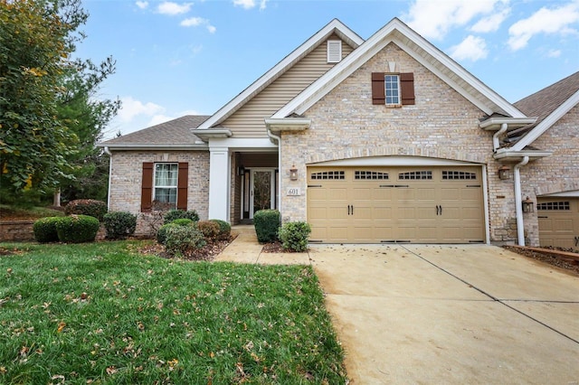 craftsman inspired home featuring a front lawn and a garage