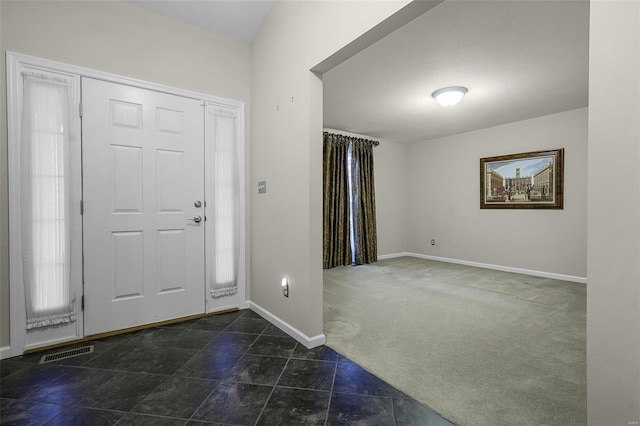 foyer with dark colored carpet