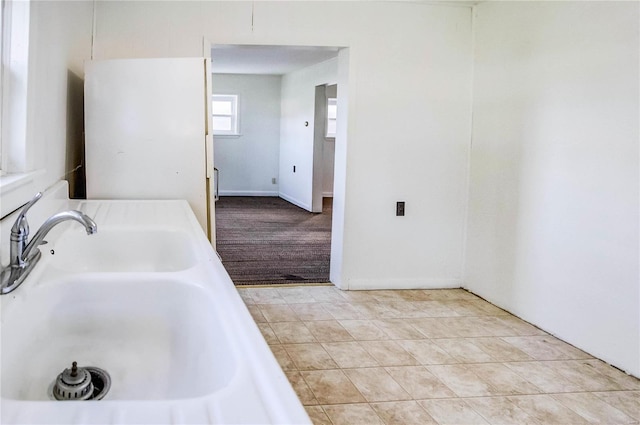 bathroom with a bathing tub and tile patterned floors