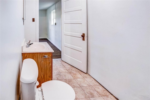 bathroom featuring vanity, toilet, and tile patterned flooring