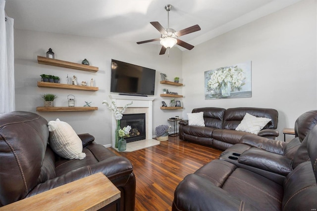 living room with hardwood / wood-style floors, vaulted ceiling, and ceiling fan