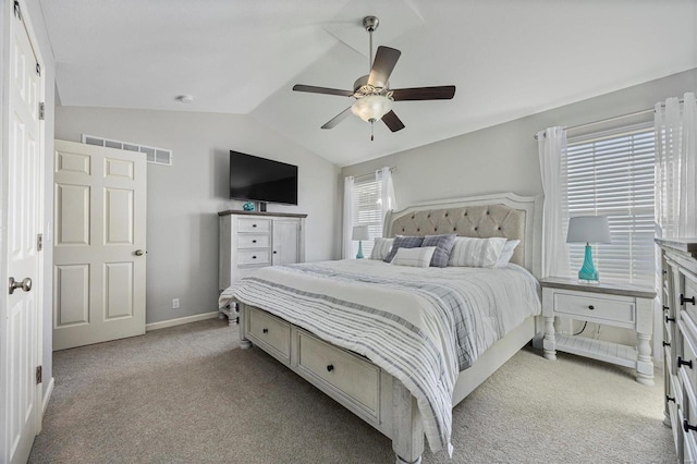 bedroom featuring lofted ceiling, light colored carpet, and ceiling fan