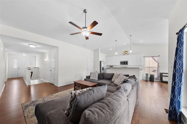 living room featuring high vaulted ceiling, ceiling fan, and dark hardwood / wood-style floors