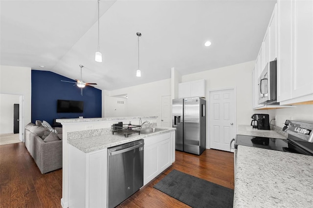 kitchen featuring white cabinets, appliances with stainless steel finishes, and pendant lighting