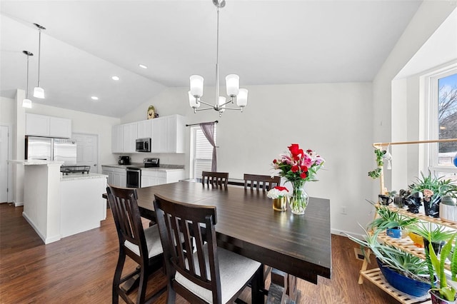 dining space with a healthy amount of sunlight, lofted ceiling, and dark hardwood / wood-style floors