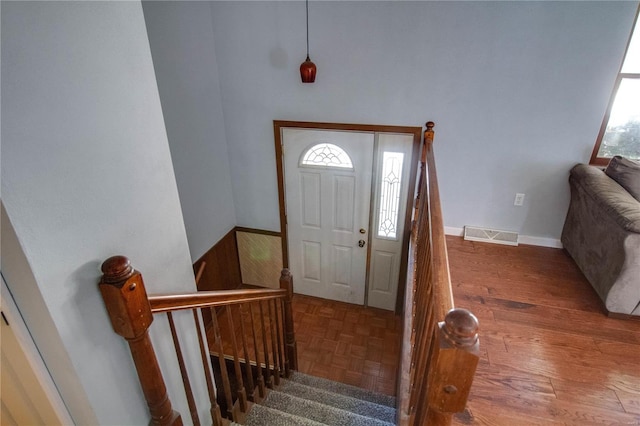 entrance foyer featuring a healthy amount of sunlight and dark hardwood / wood-style floors