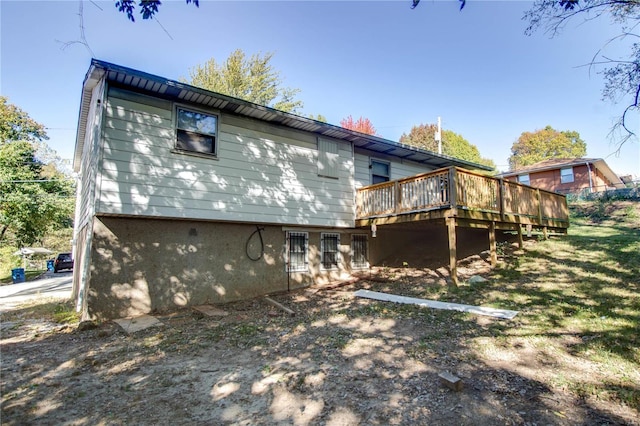 rear view of house with a wooden deck