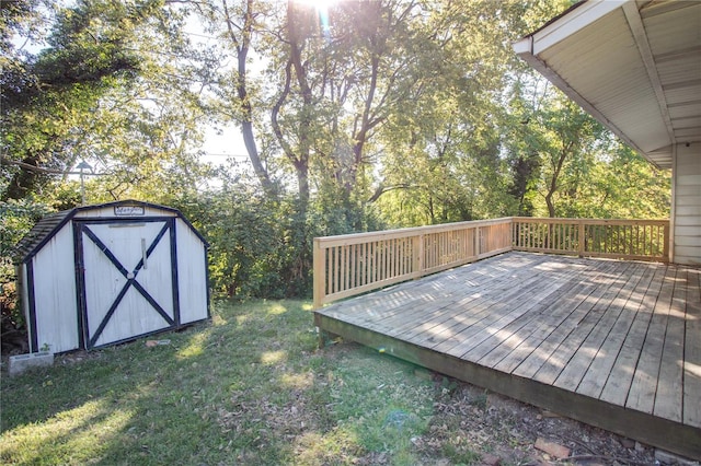 wooden terrace featuring a storage unit and a yard