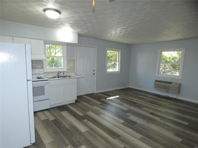 kitchen featuring a wealth of natural light, dark wood-type flooring, white appliances, and white cabinetry