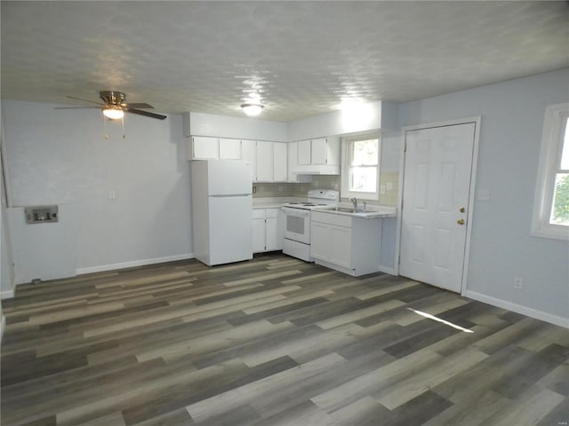 kitchen featuring dark wood-type flooring, sink, white appliances, and white cabinetry