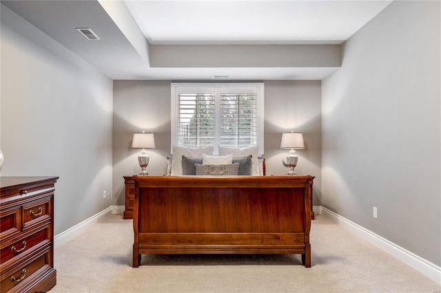 carpeted bedroom with visible vents and baseboards