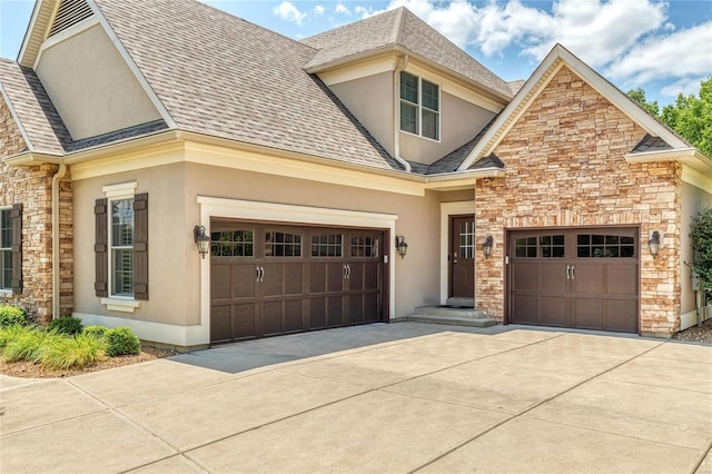 view of front of home featuring roof with shingles, an attached garage, stucco siding, concrete driveway, and stone siding