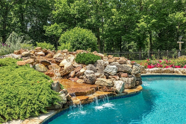 view of swimming pool featuring fence and a fenced in pool