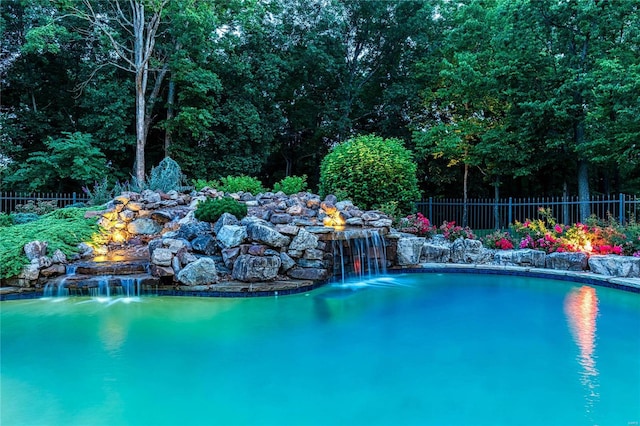 view of swimming pool with fence