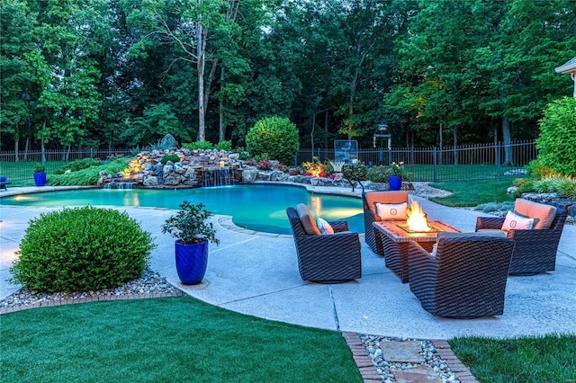 view of pool with a fenced in pool, a fire pit, fence, a lawn, and a patio