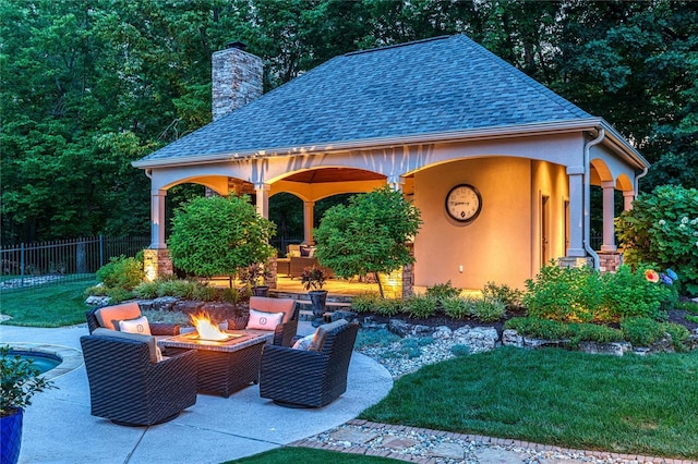 view of patio featuring a fire pit and fence