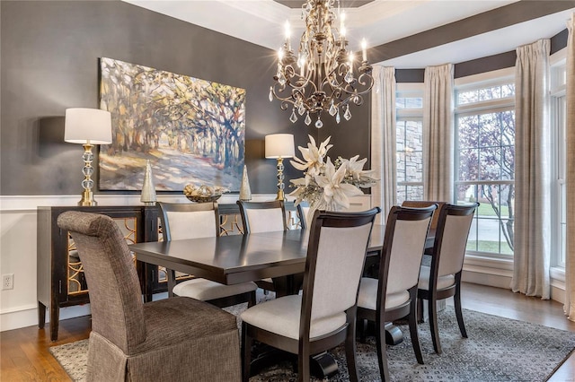 dining space featuring a chandelier, plenty of natural light, and wood finished floors