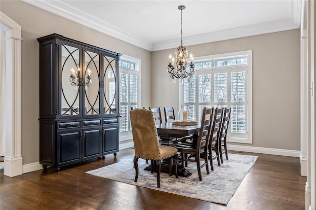 dining space with a wealth of natural light, a notable chandelier, baseboards, and dark wood-style floors