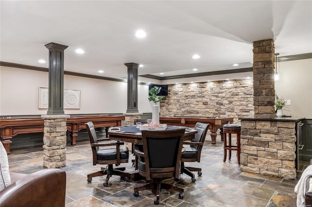 dining room with recessed lighting, stone finish floor, ornamental molding, and ornate columns