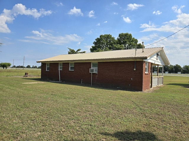 view of home's exterior featuring cooling unit and a lawn